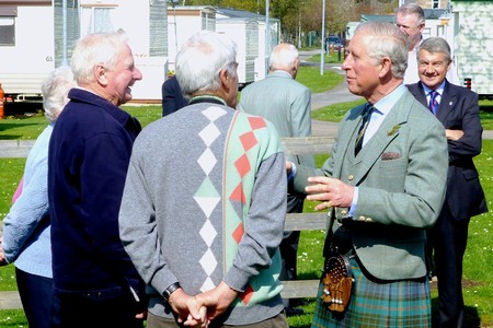 A group of holiday makers chat with Prince Charles