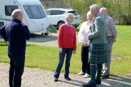 Prince Charles talks to two couples staying in the touring section